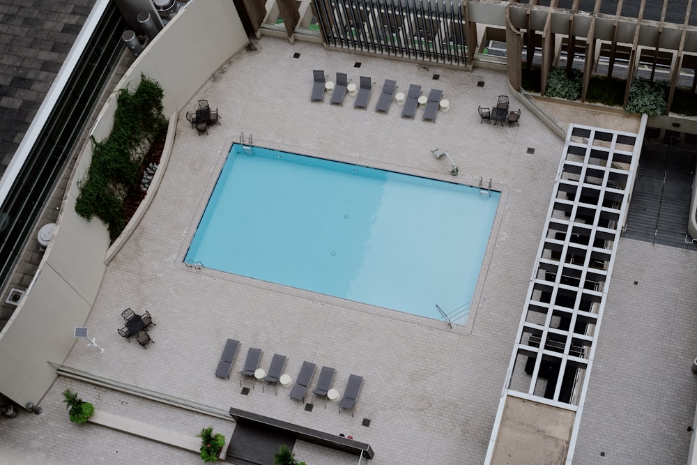 an aerial view of a swimming pool and lounge chairs