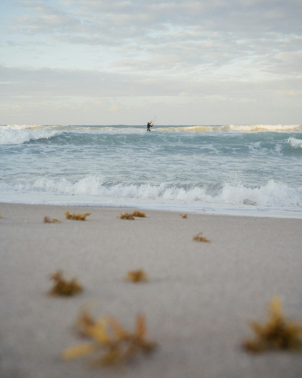 a person riding a surfboard on top of a wave