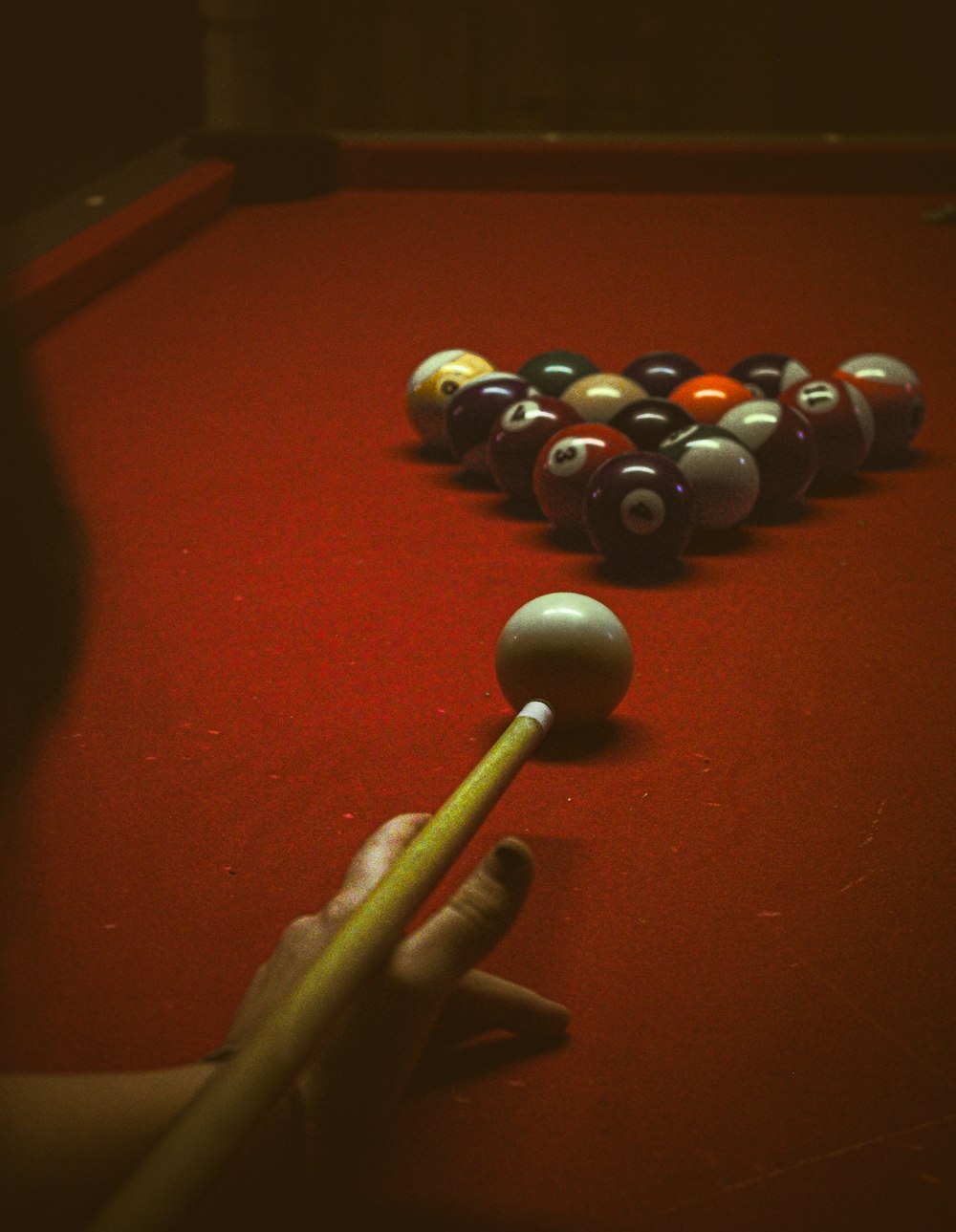 a pool table with eight balls and a cue