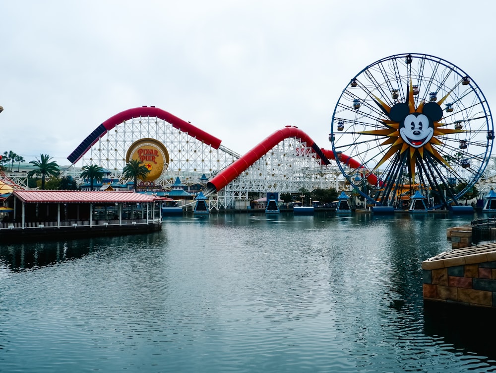 an amusement park with a ferris wheel and a mickey mouse ride