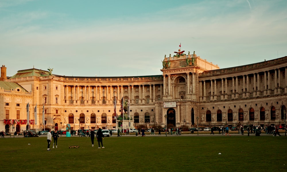 a group of people standing in front of a large building