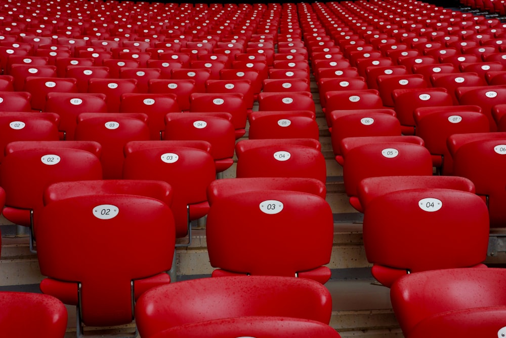 rows of red seats in a stadium filled with red seats