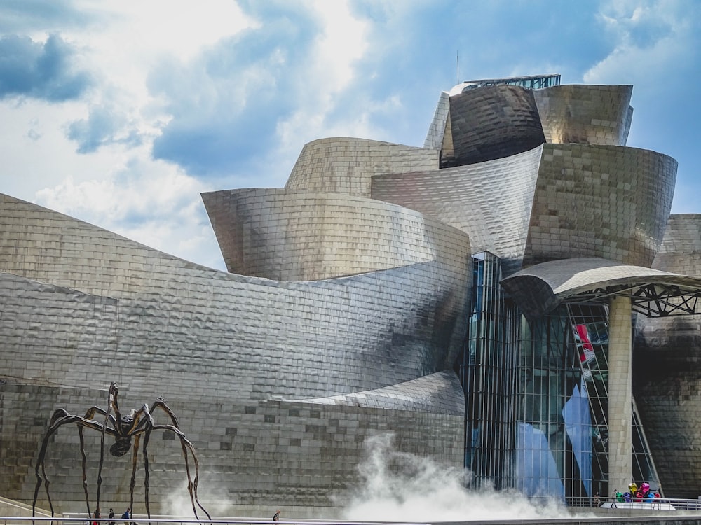 a large building with a giant spider sculpture in front of it