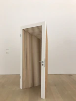 an open door in the middle of a wooden floor