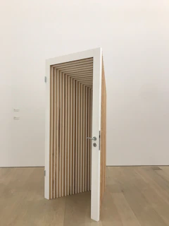an open door in the middle of a wooden floor