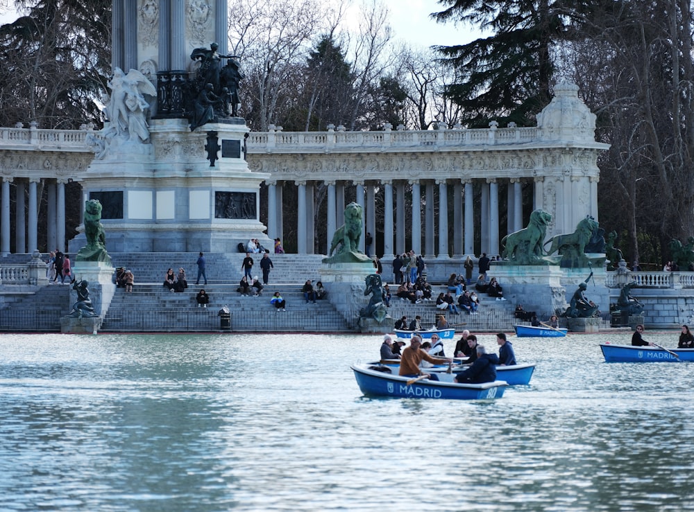 a group of people in a small boat in a body of water