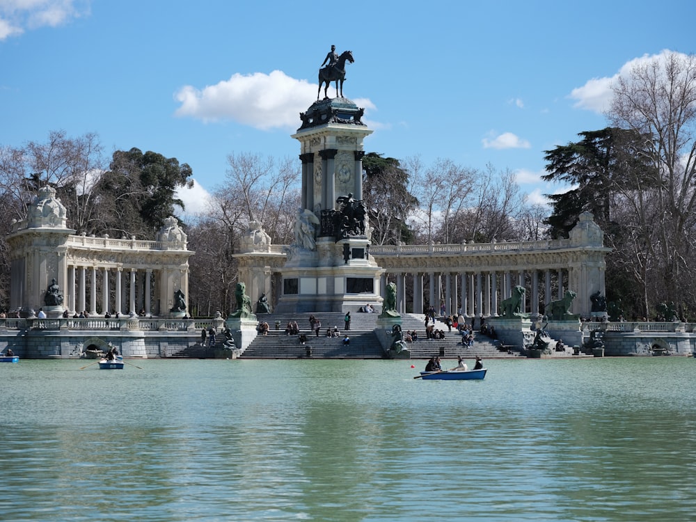 a statue of a man on a horse and a boat in the water