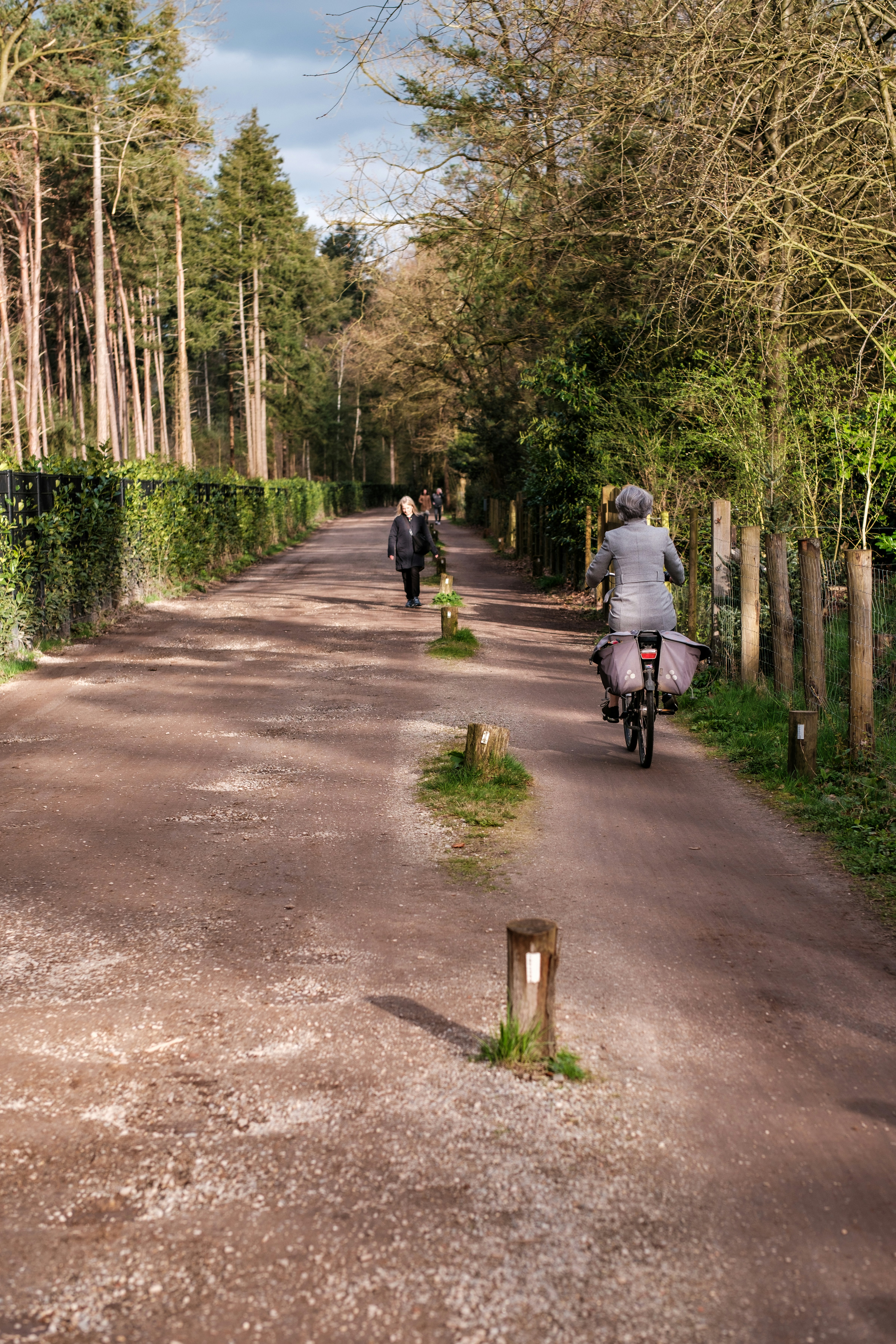 a person riding a bike down a dirt road