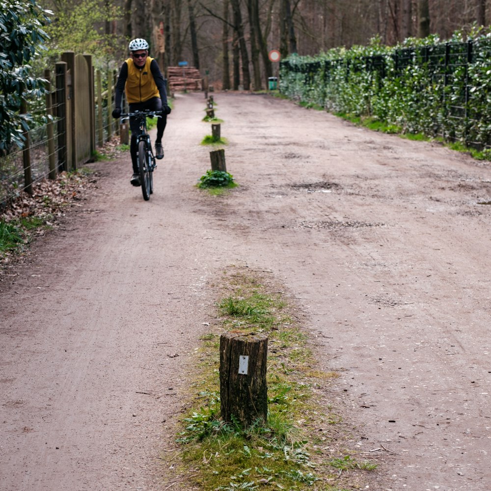 a person riding a bike down a dirt road