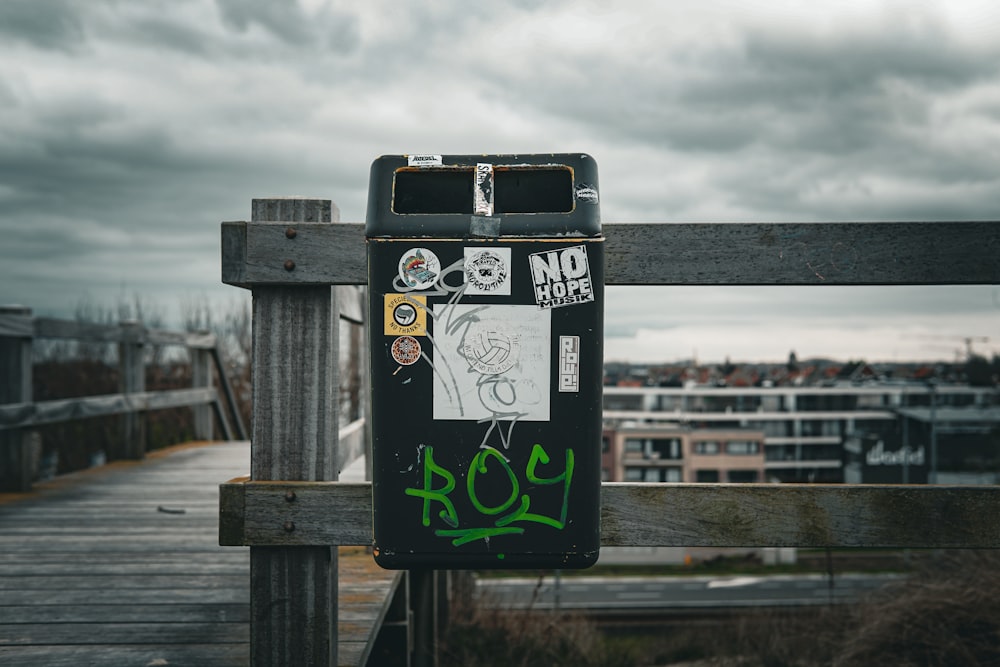 a black and green box with graffiti on it