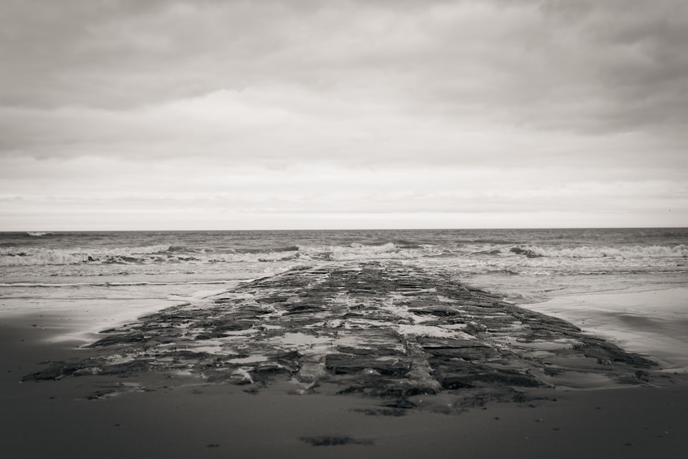 a black and white photo of a beach