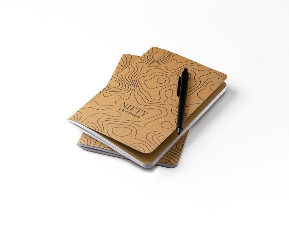 a notebook with a pen on top of it