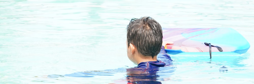 a person in the water with an umbrella