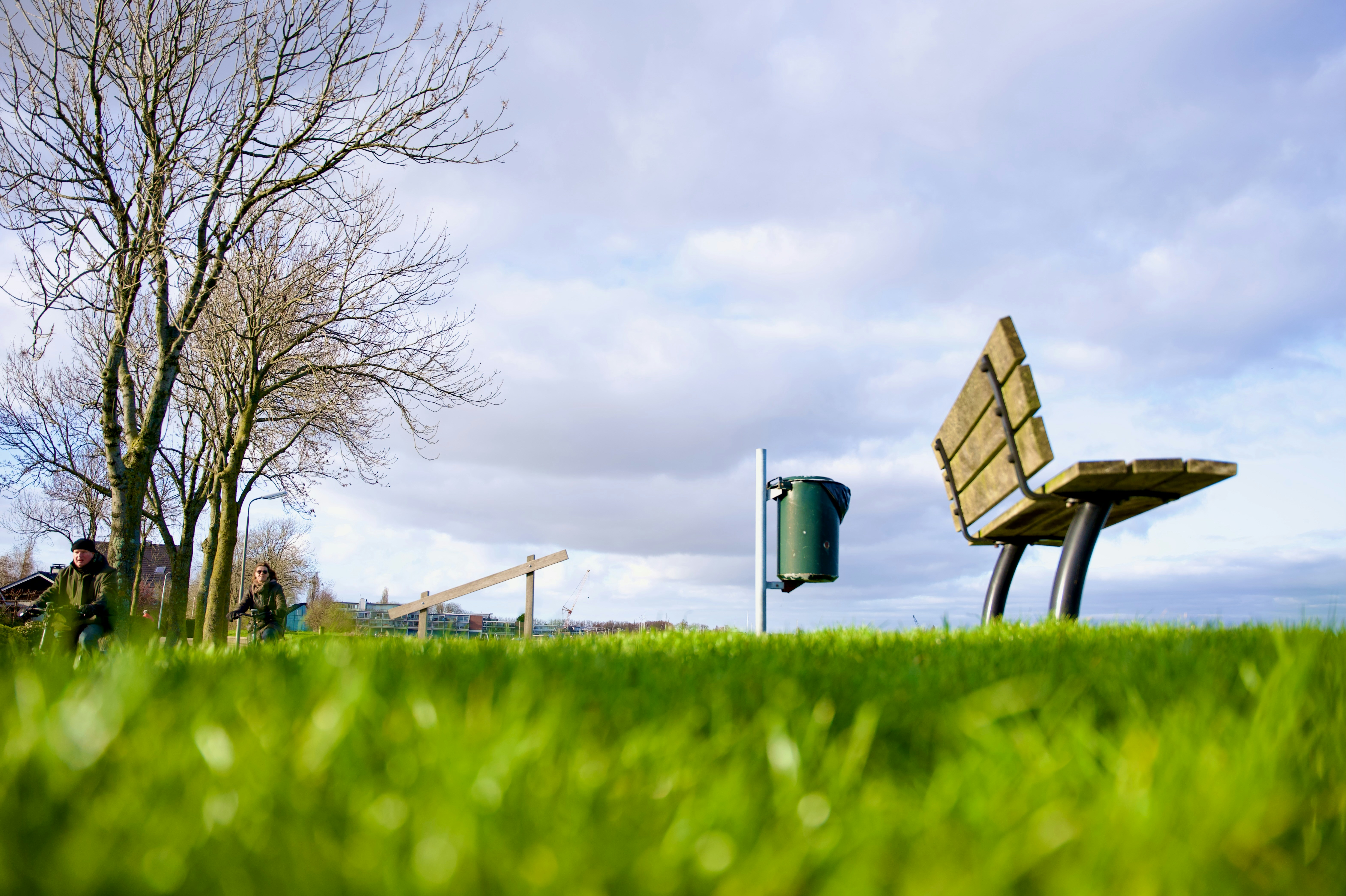 a park bench sitting on top of a lush green field