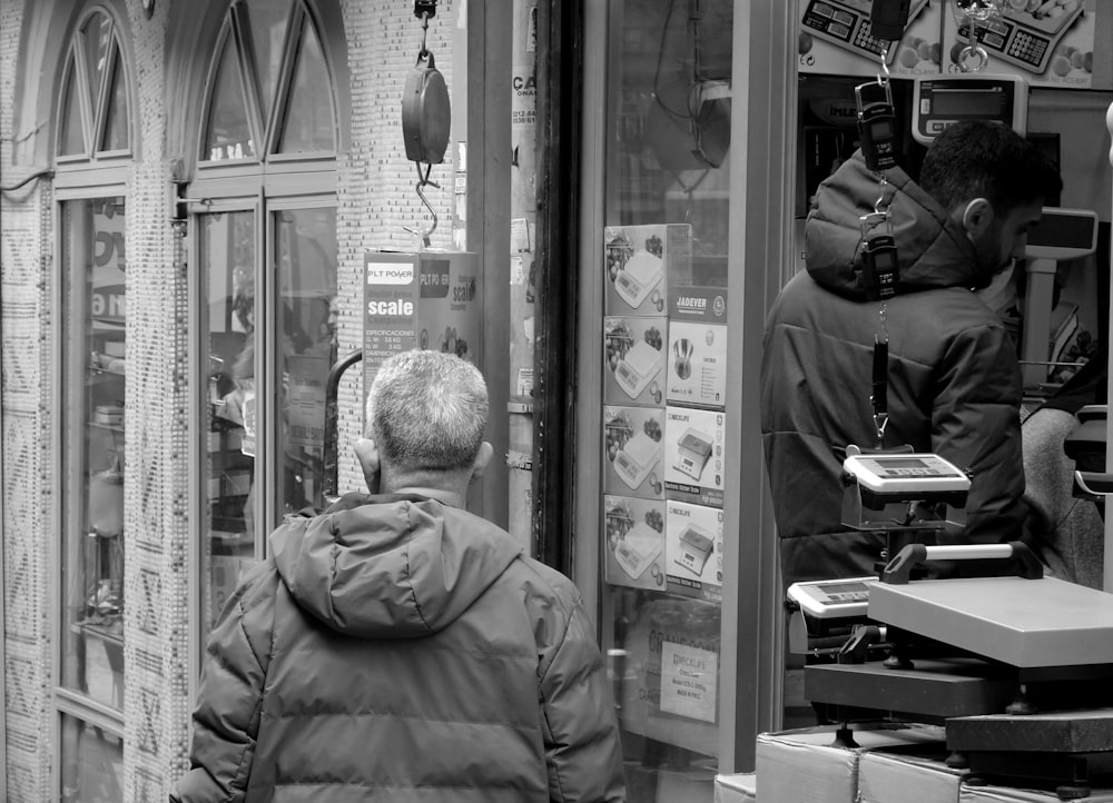 a man standing in front of a store window