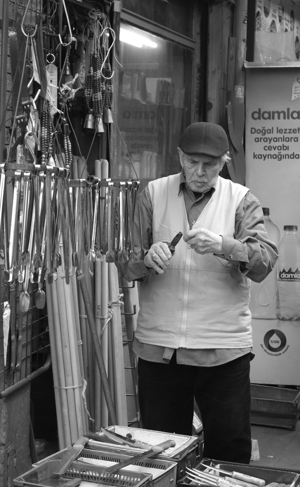 a man standing in front of a store looking at a cell phone