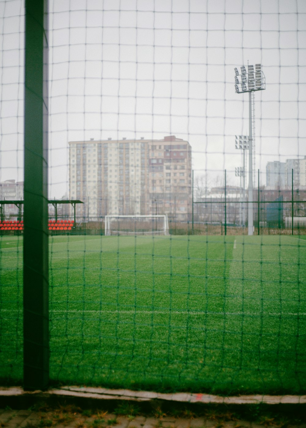 a view of a soccer field through a fence