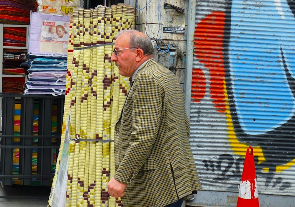 a man walking down a street past a store