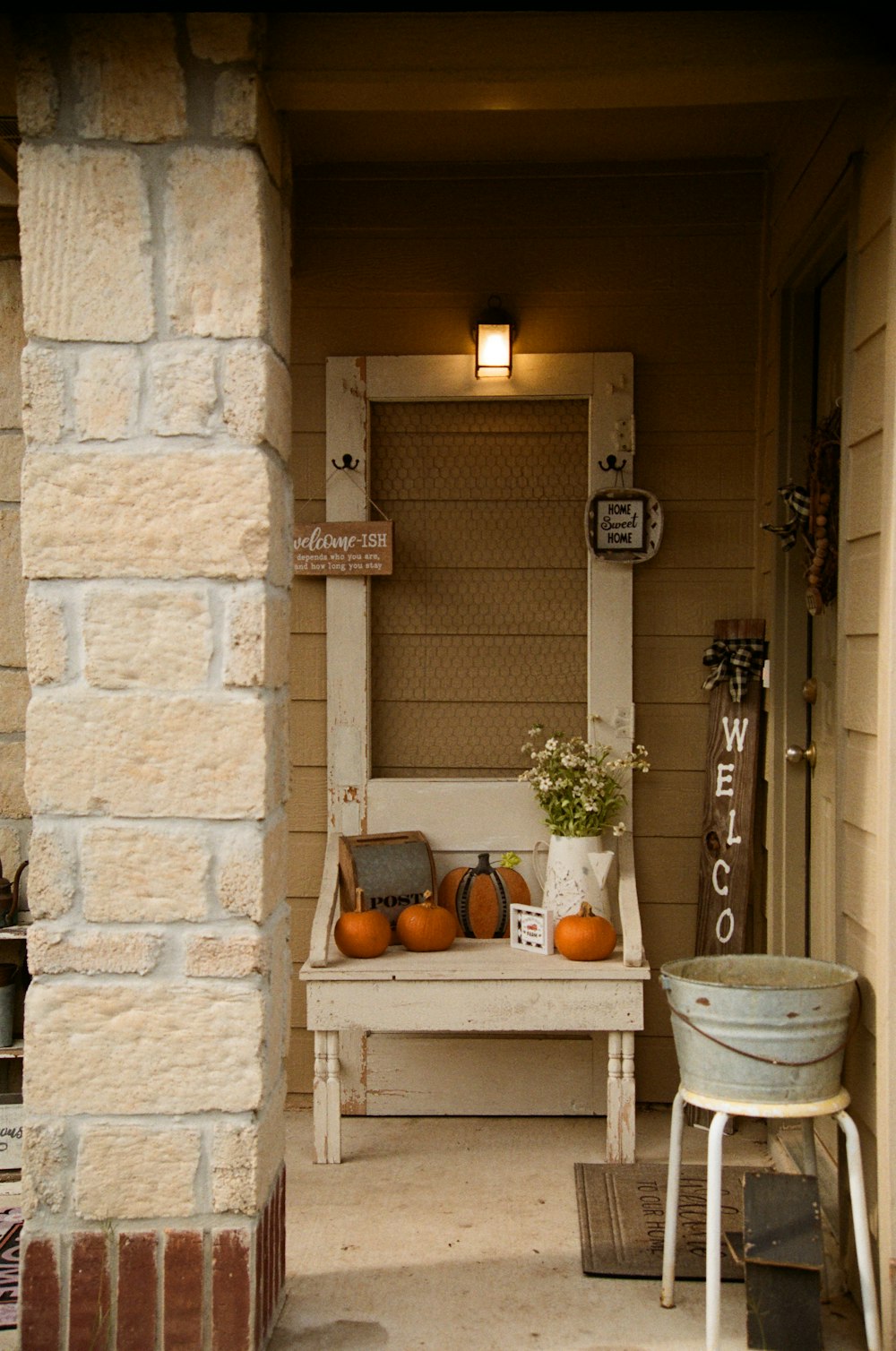 a porch with a bench and a potted plant