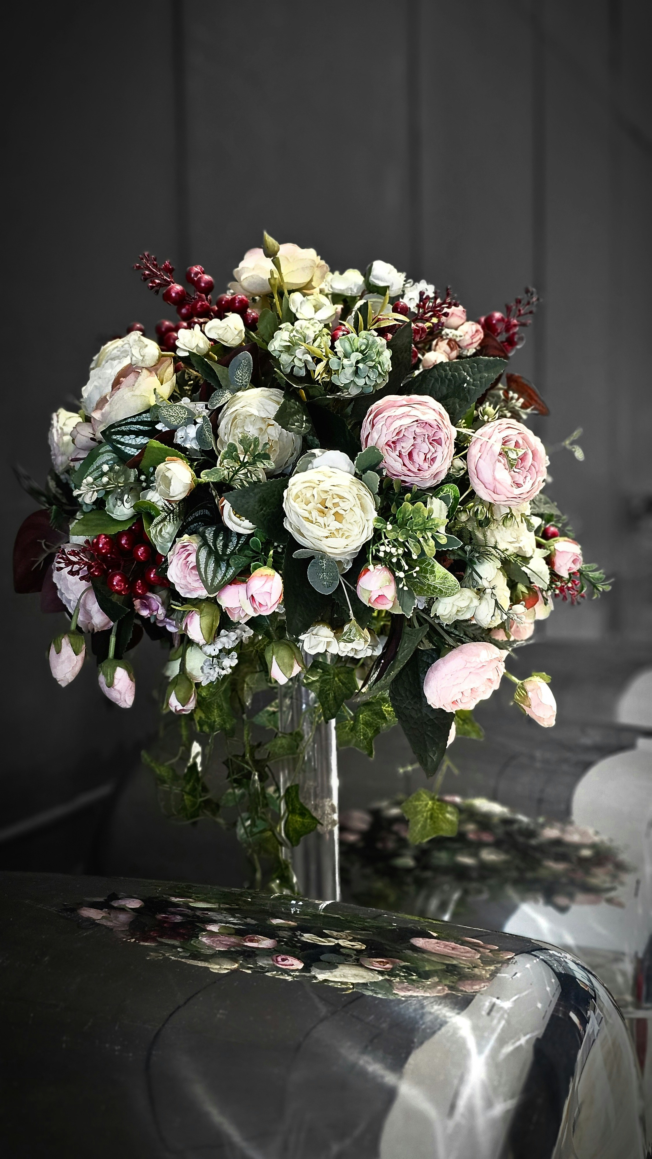a vase filled with lots of flowers on top of a table