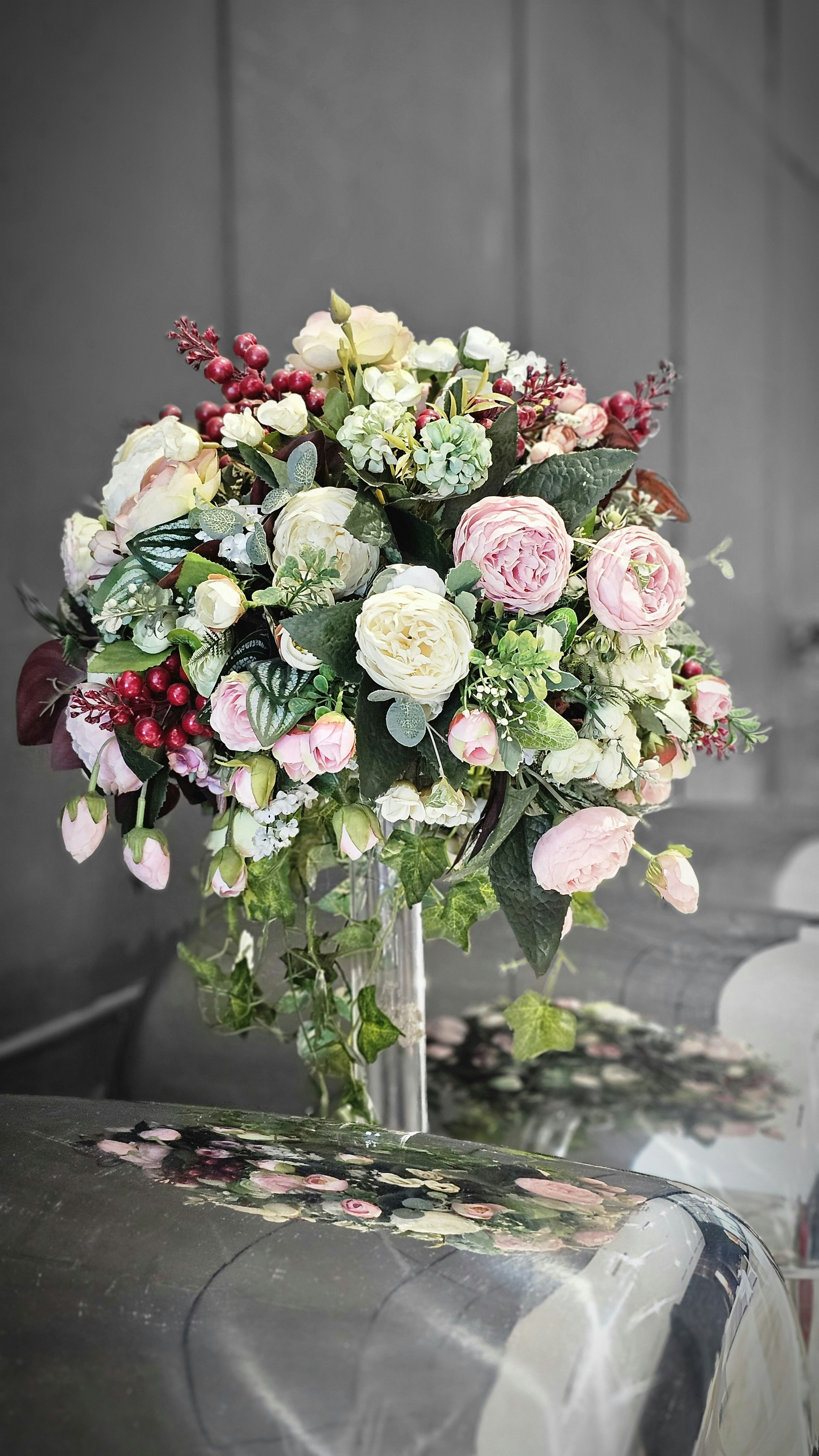 a vase filled with lots of flowers on top of a table