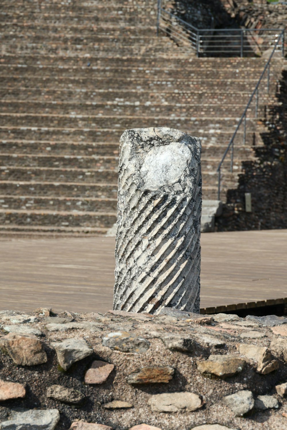 a stone pillar in front of some steps