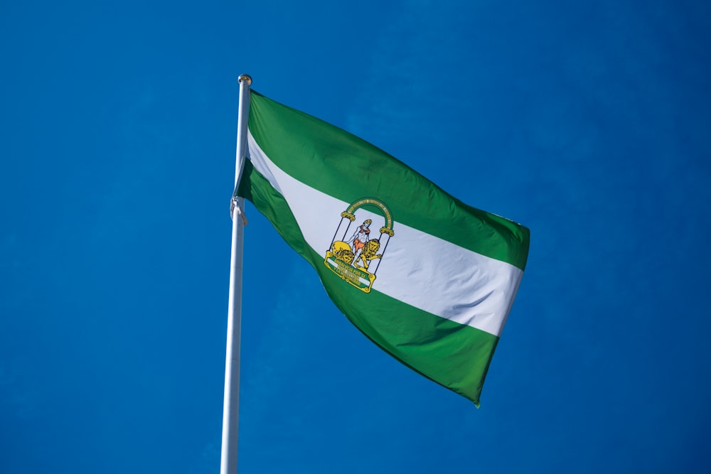 a green and white flag flying in the sky