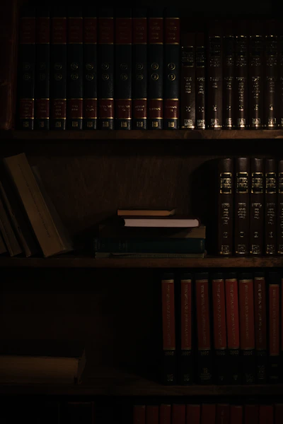 a bookshelf filled with lots of books in a dark room