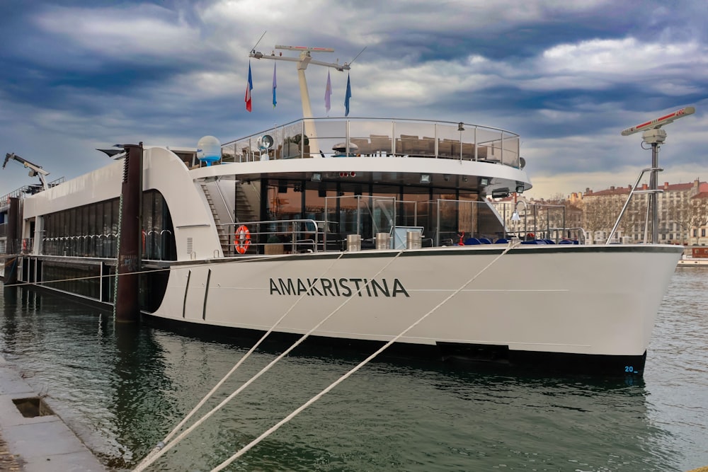 a large white boat docked at a pier