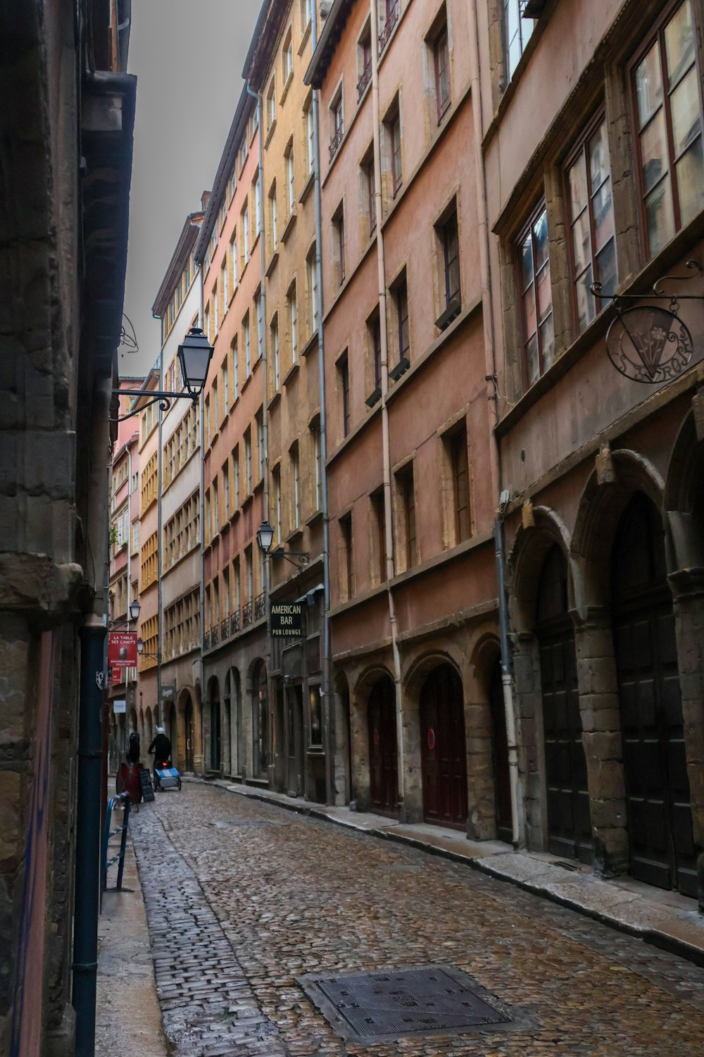 a cobblestone street lined with tall buildings