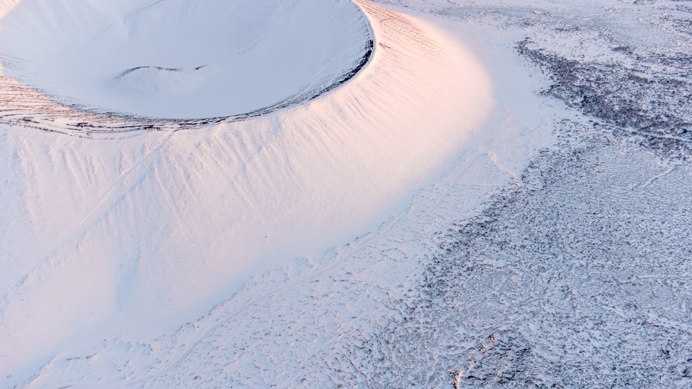 an aerial view of a snow covered field