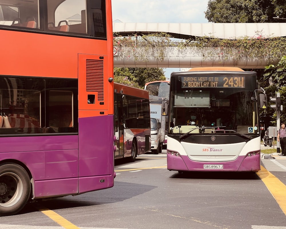 a couple of buses that are sitting in the street