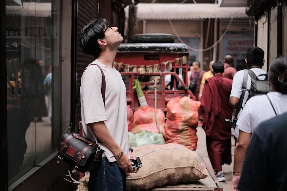 a man standing next to a pile of bags