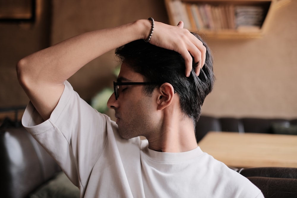 a man in a white shirt and black glasses