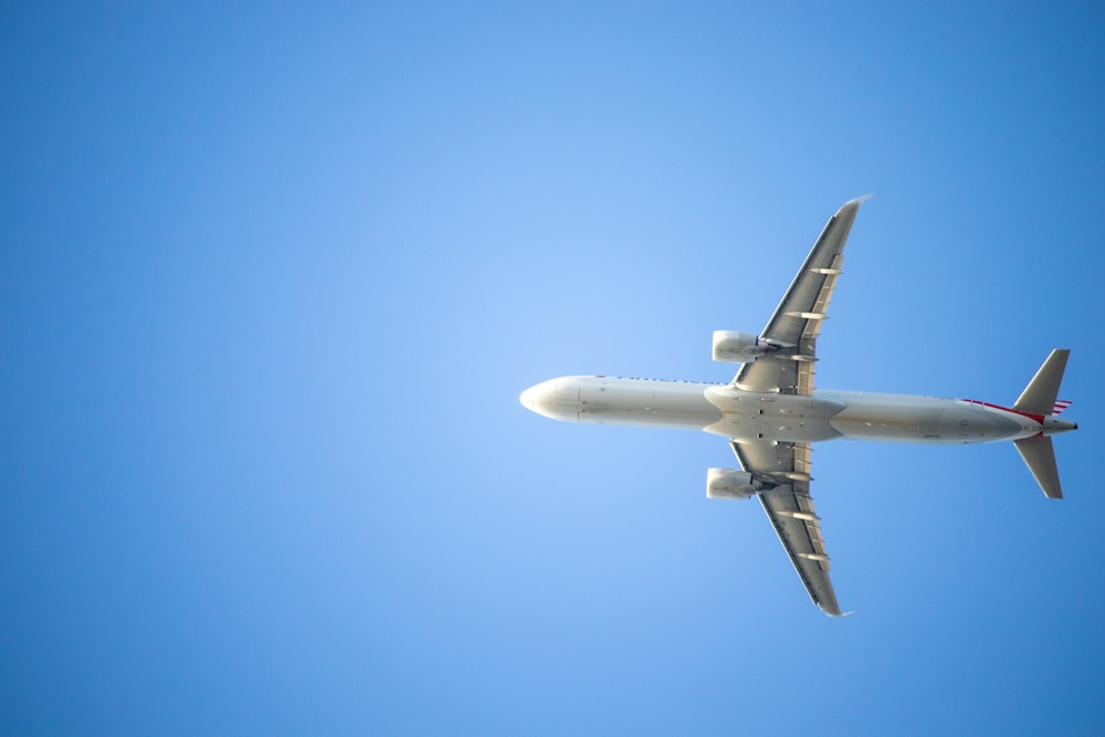 a large jetliner flying through a blue sky