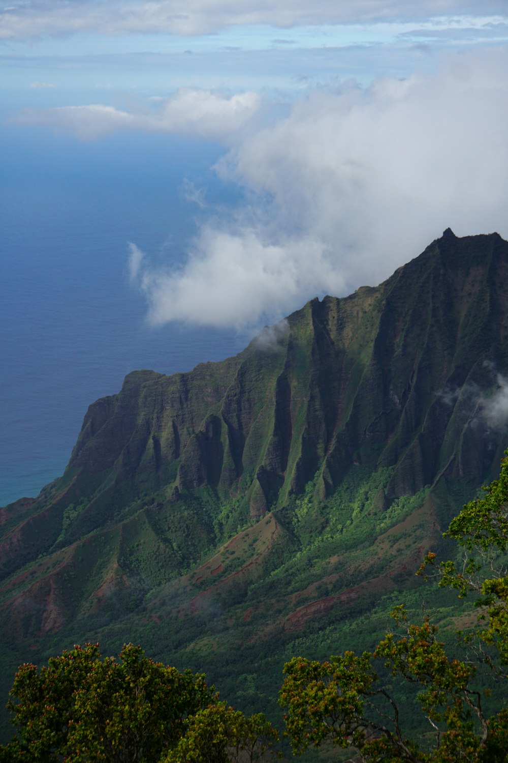 a view of a mountain with clouds in the sky