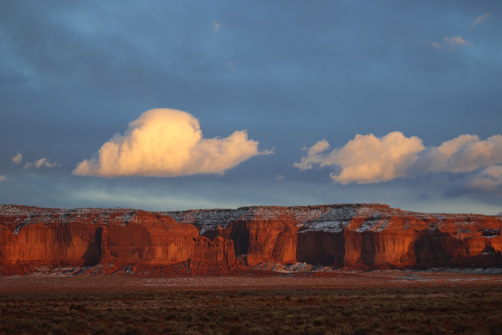 a large mountain with some clouds in the sky