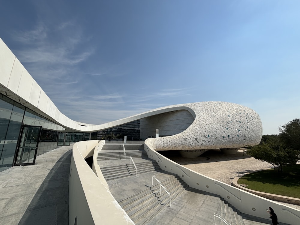 a building with a curved roof and stairs