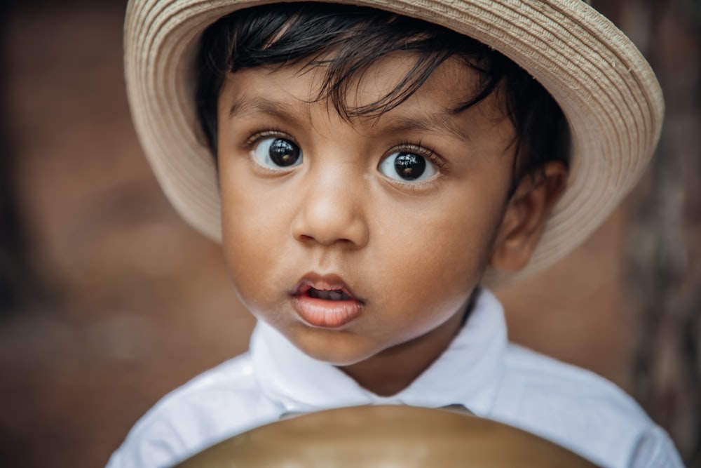 a little boy with a hat on his head