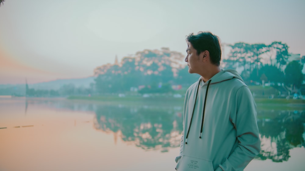 a man standing in front of a body of water