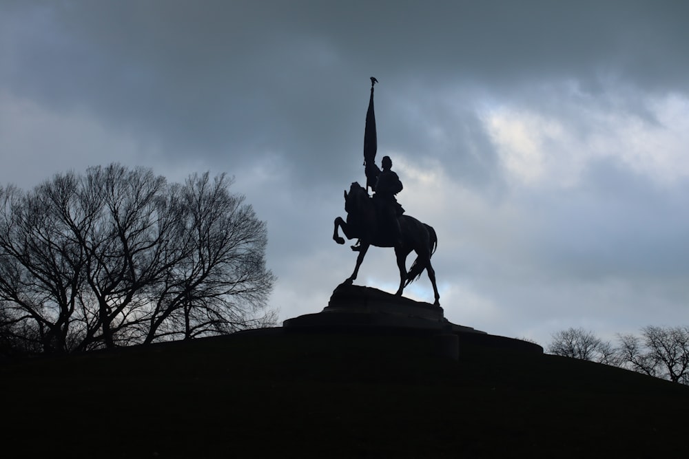a statue of a man on a horse holding a flag
