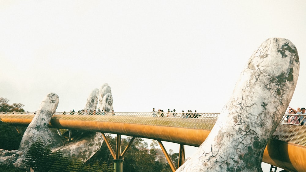 a wooden bridge with people walking across it