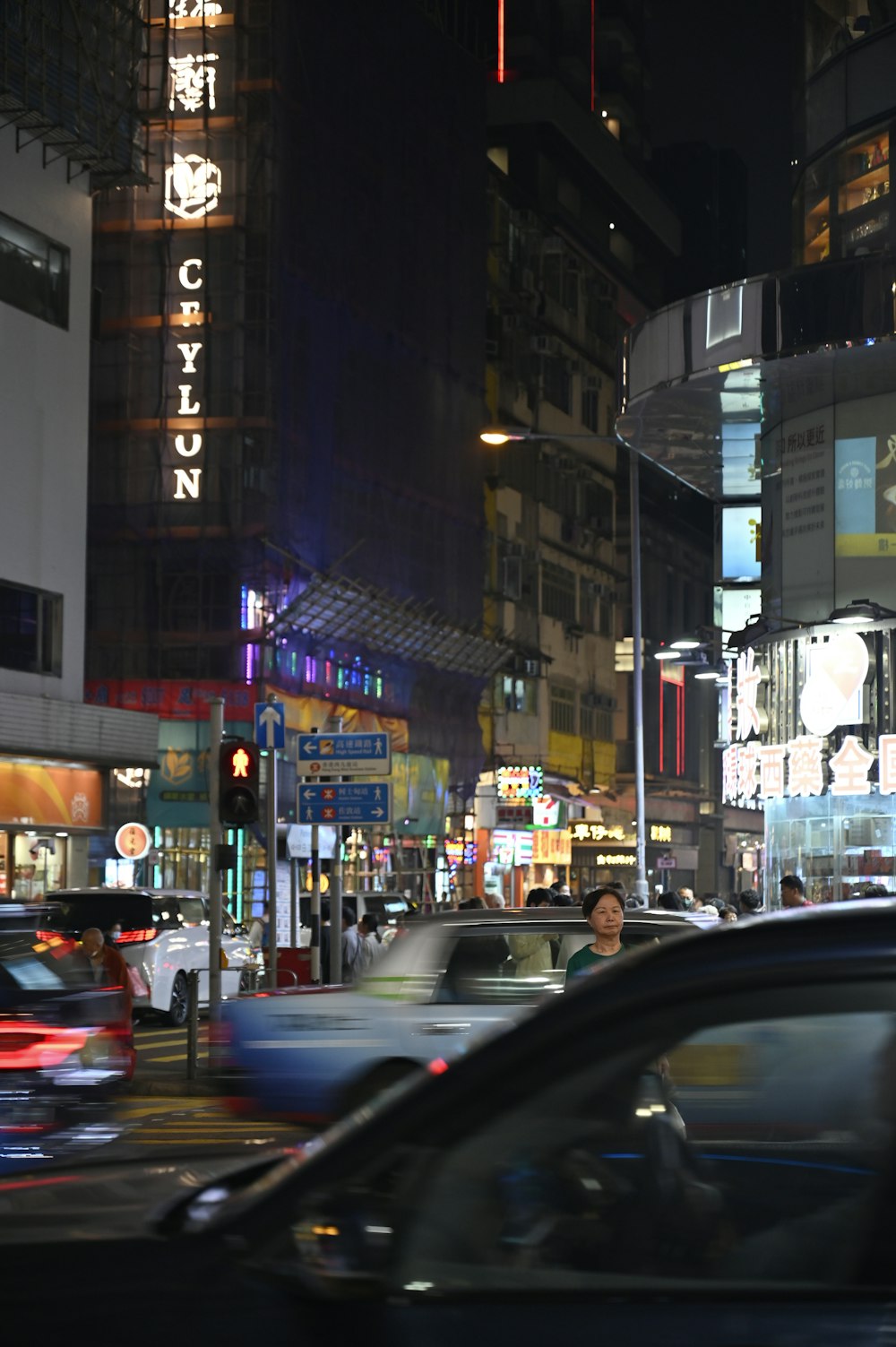 a city street filled with lots of traffic at night