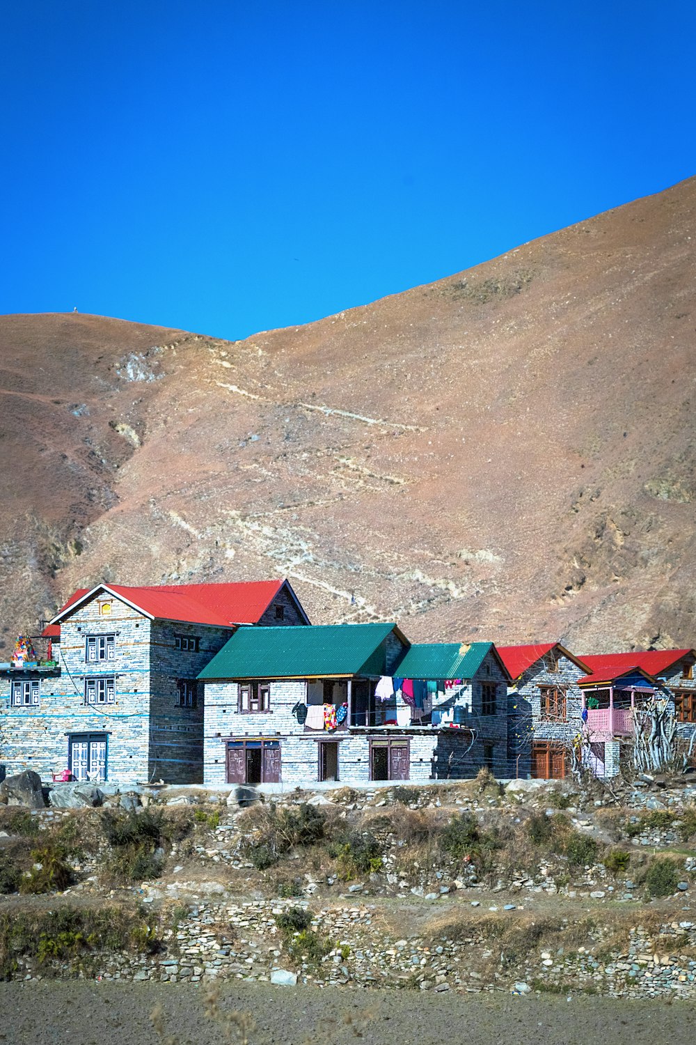 a group of buildings with a mountain in the background