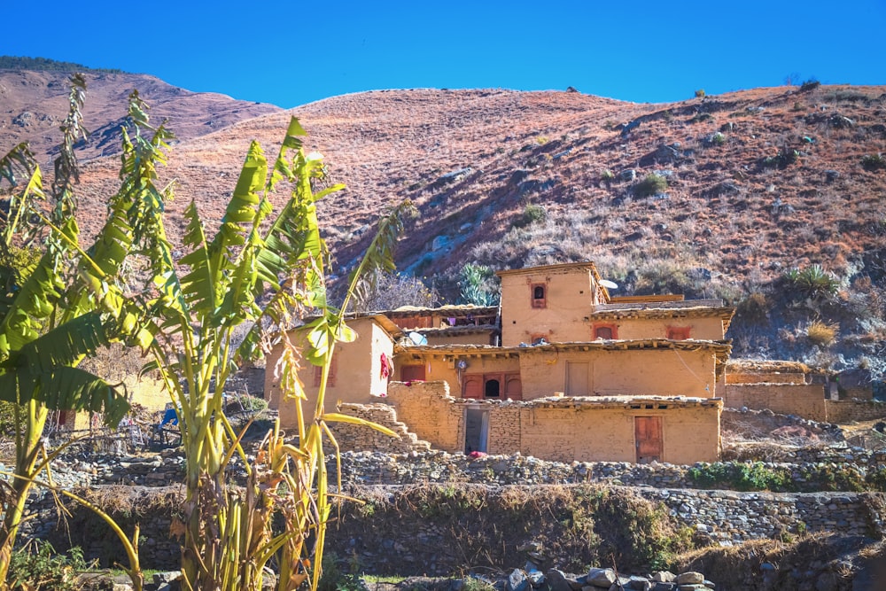 a small adobe building in the middle of a desert