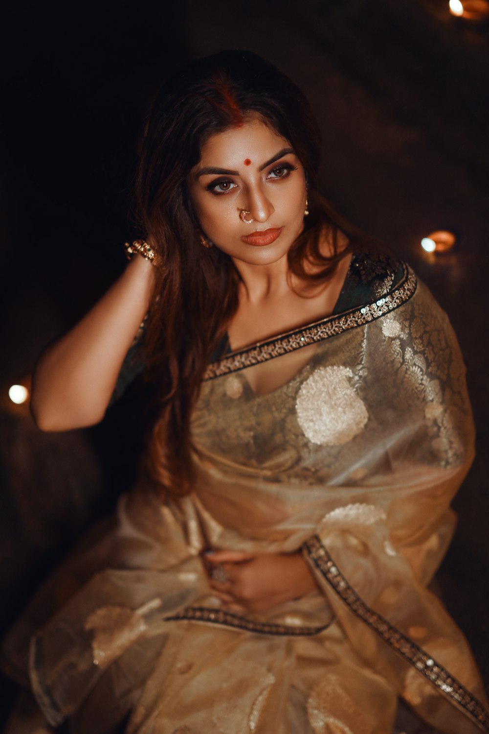 a woman in a sari posing for a picture