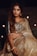 a woman in a white and gold sari