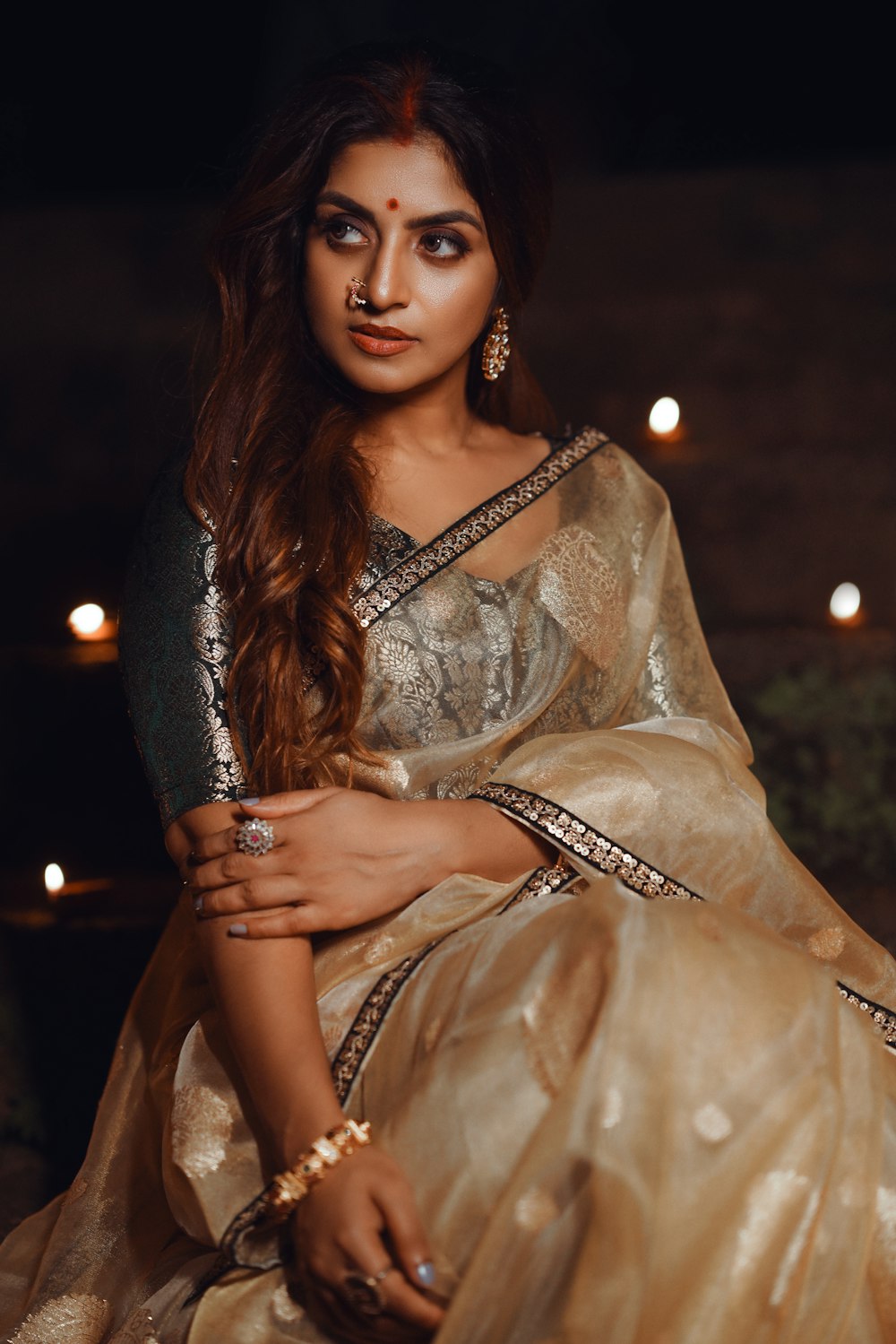 a woman in a white and gold sari