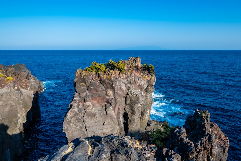 a rocky outcropping in the middle of the ocean