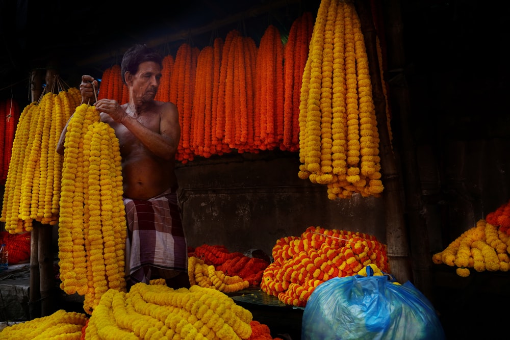 a man standing in front of a display of corn